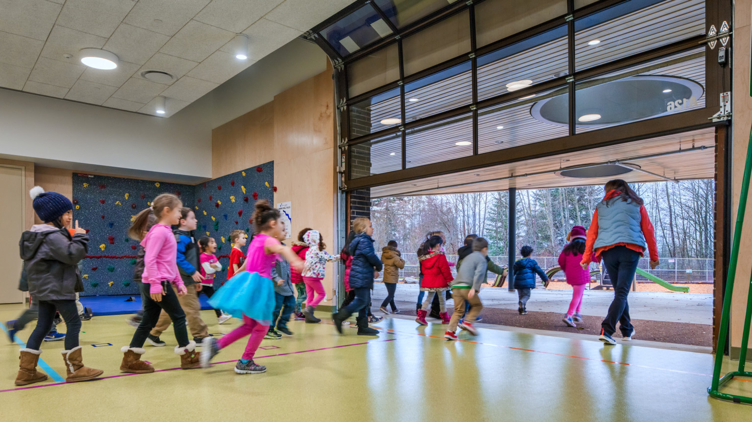 Children exiting out garage style door at Pathfinder Elementary School