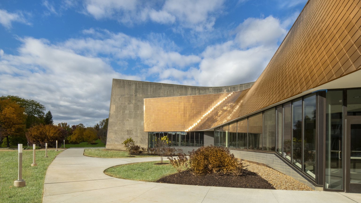 copper glass and concrete facade building against a blue sky copper glass and concrete facade building against a blue sky