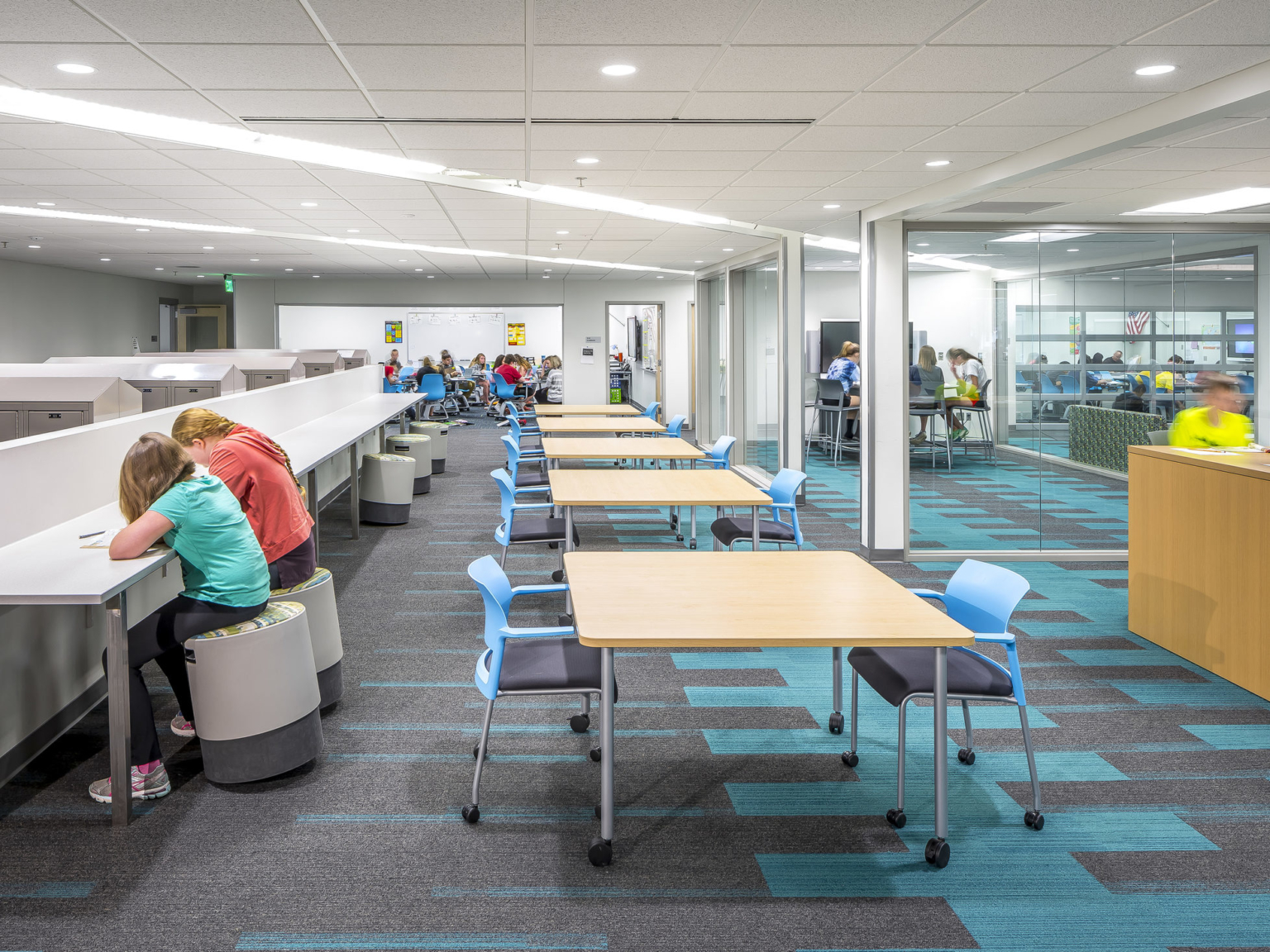 k12 learning and collaboration space with flexible furniture, media walls, and varying workstations to accommodate different group sizes at jordan middle school
