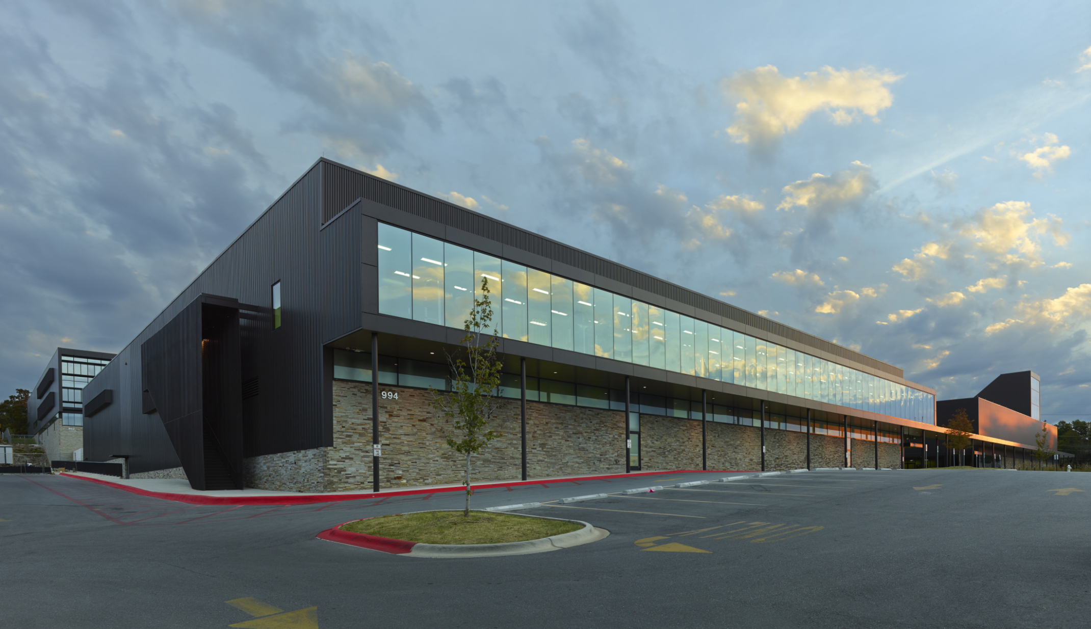 Evening view of seamless windows spanning entire length of Fayetteville High School. Evening view of seamless windows spanning entire length of Fayetteville High School.