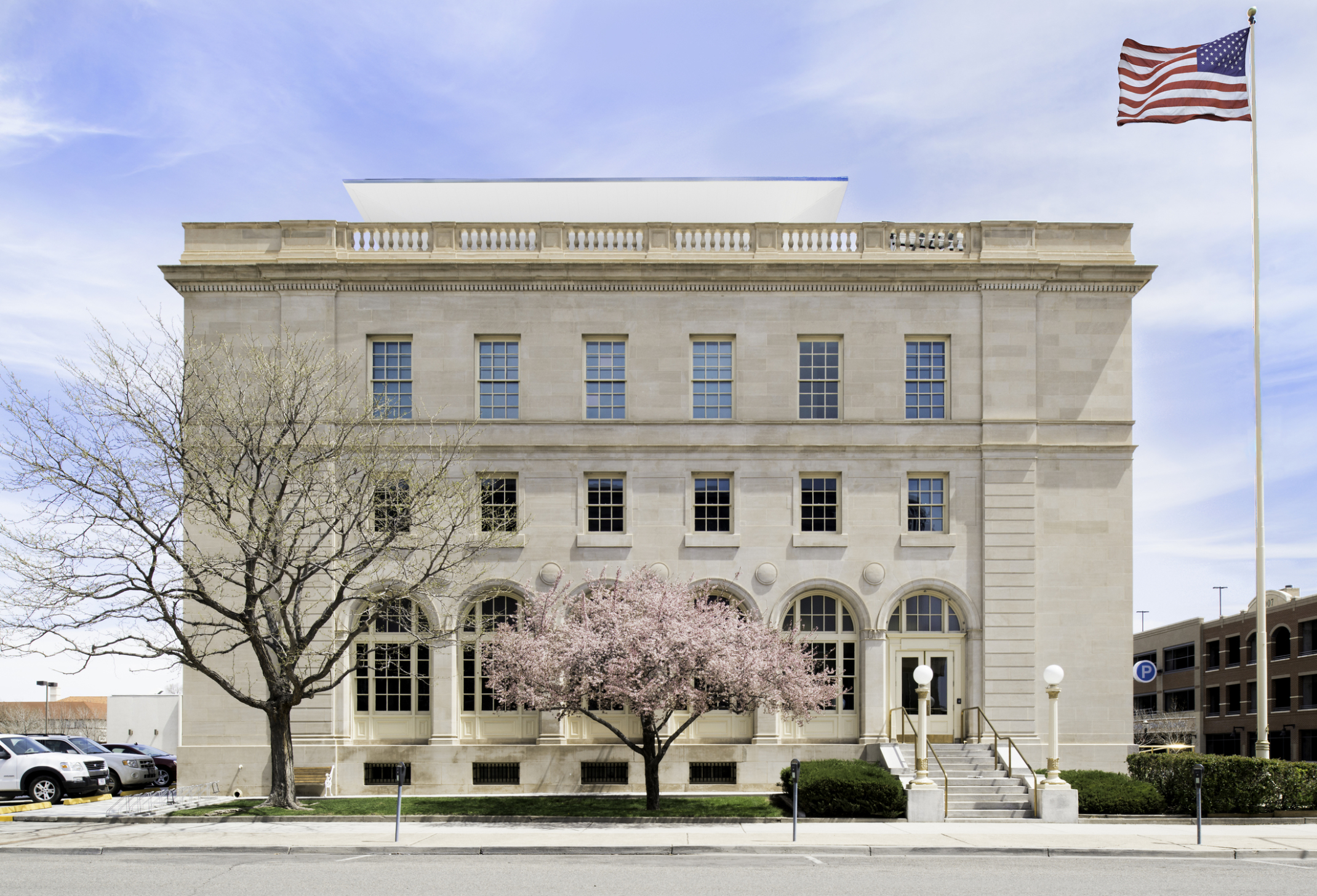the exterior of the wayne aspinall federal building with a pink flowering tree in the foreground the exterior of the wayne aspinall federal building with a pink flowering tree in the foreground