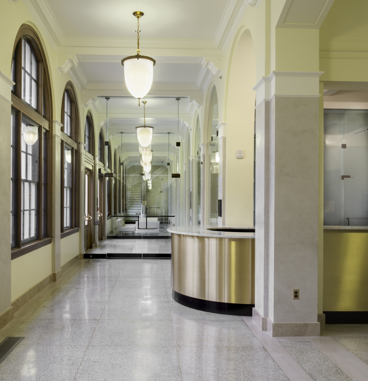 reception desk in front of a mirrored hallway