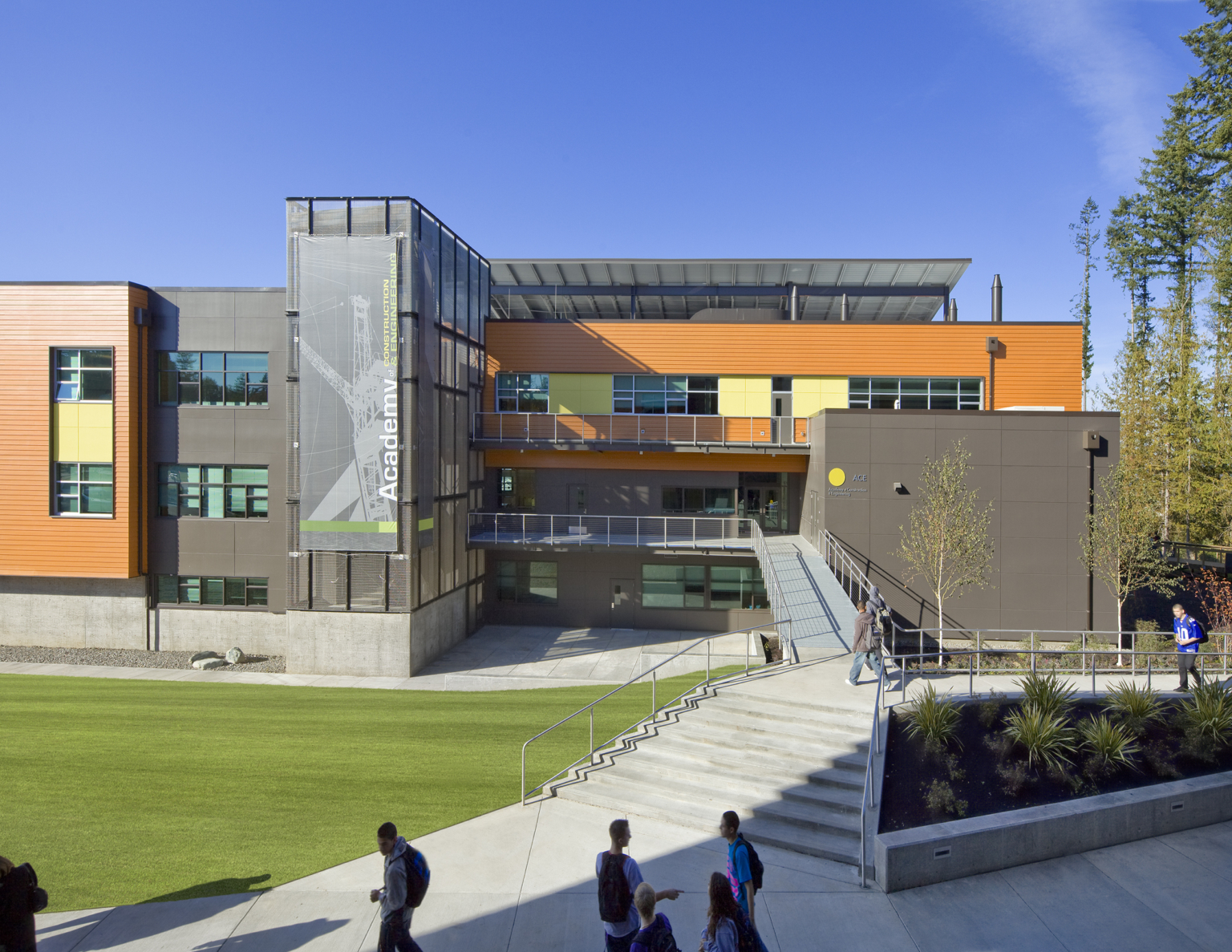 Stairwell up to Marysville Getchell High School with orange facade and metal jut-out at Marysville Getchell High School.