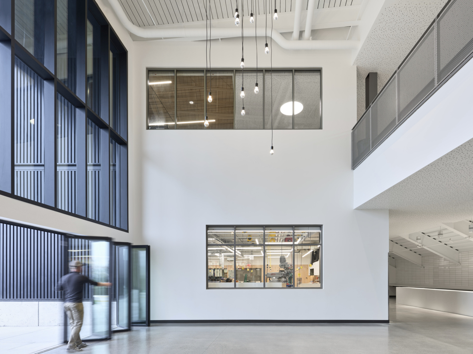 Double height atrium with retractable doors at Discovery High School.