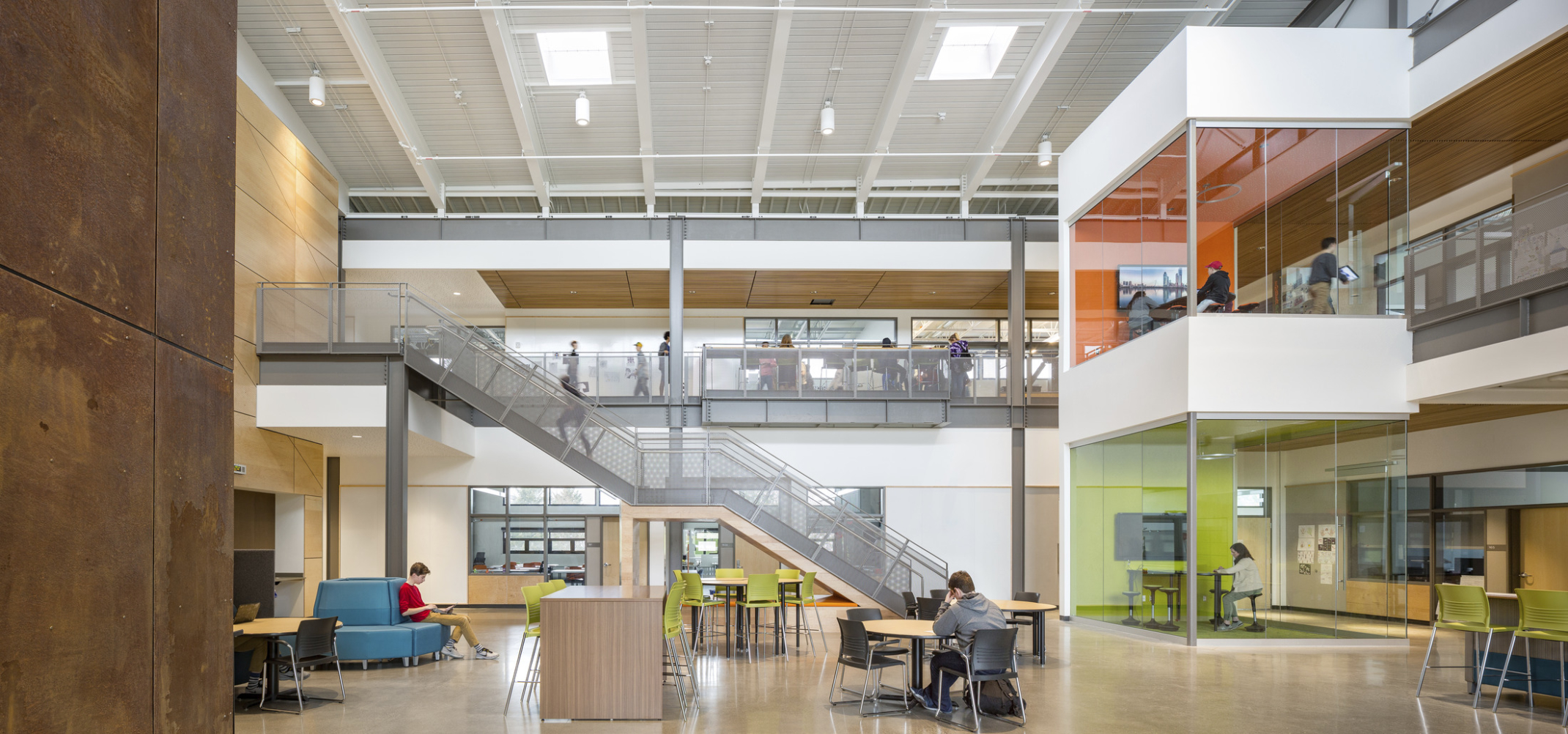 Main atrium area with double height ceiling, glass learning pods, learning stair, and flexible seating at Discovery High School. Main atrium area with double height ceiling, glass learning pods, learning stair, and flexible seating at Discovery High School.