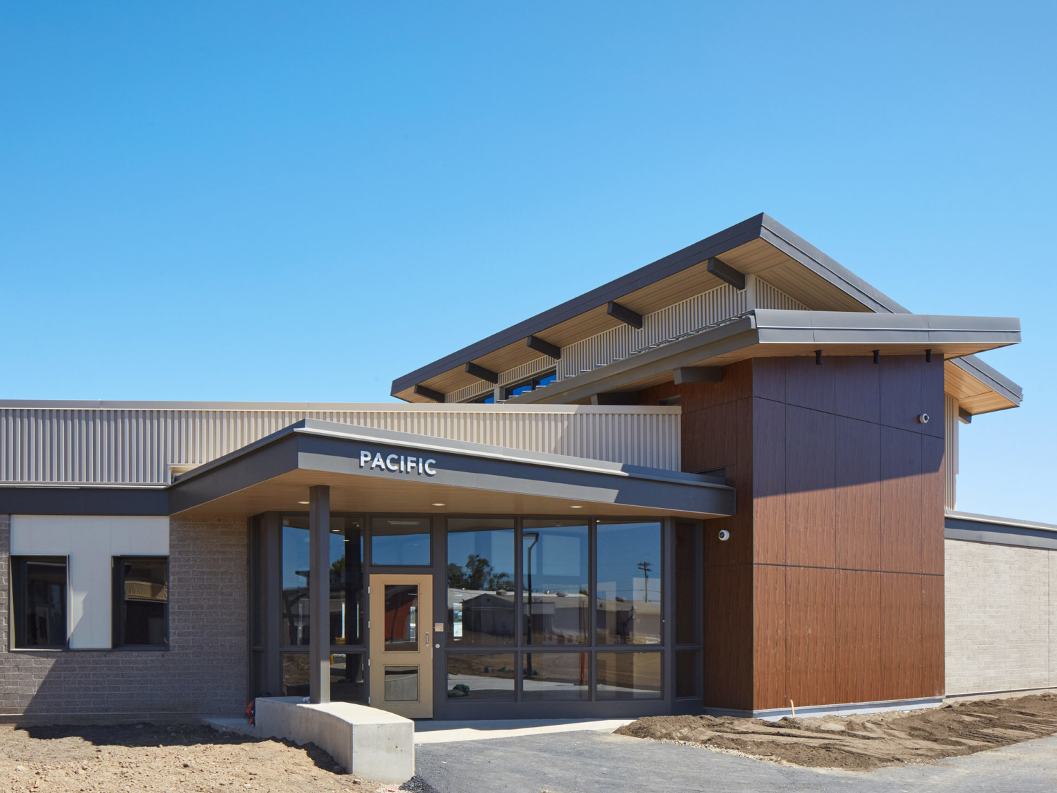 exterior daytime view of the pacific building entrance with a clear blue sky