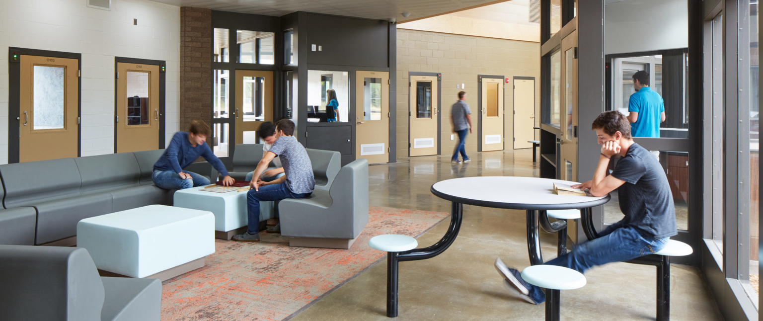 lounge area inside a building with people seated and walking around
