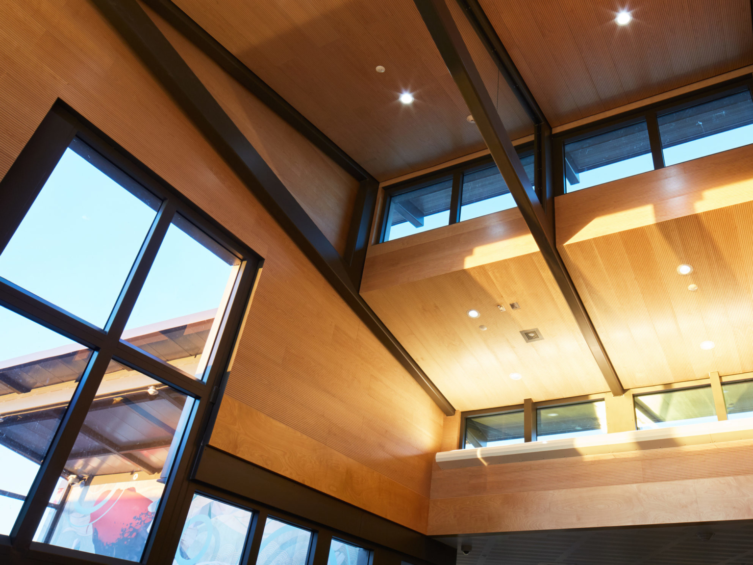 an angled view of the ceiling inside one of buildings showing off the windows and lighting