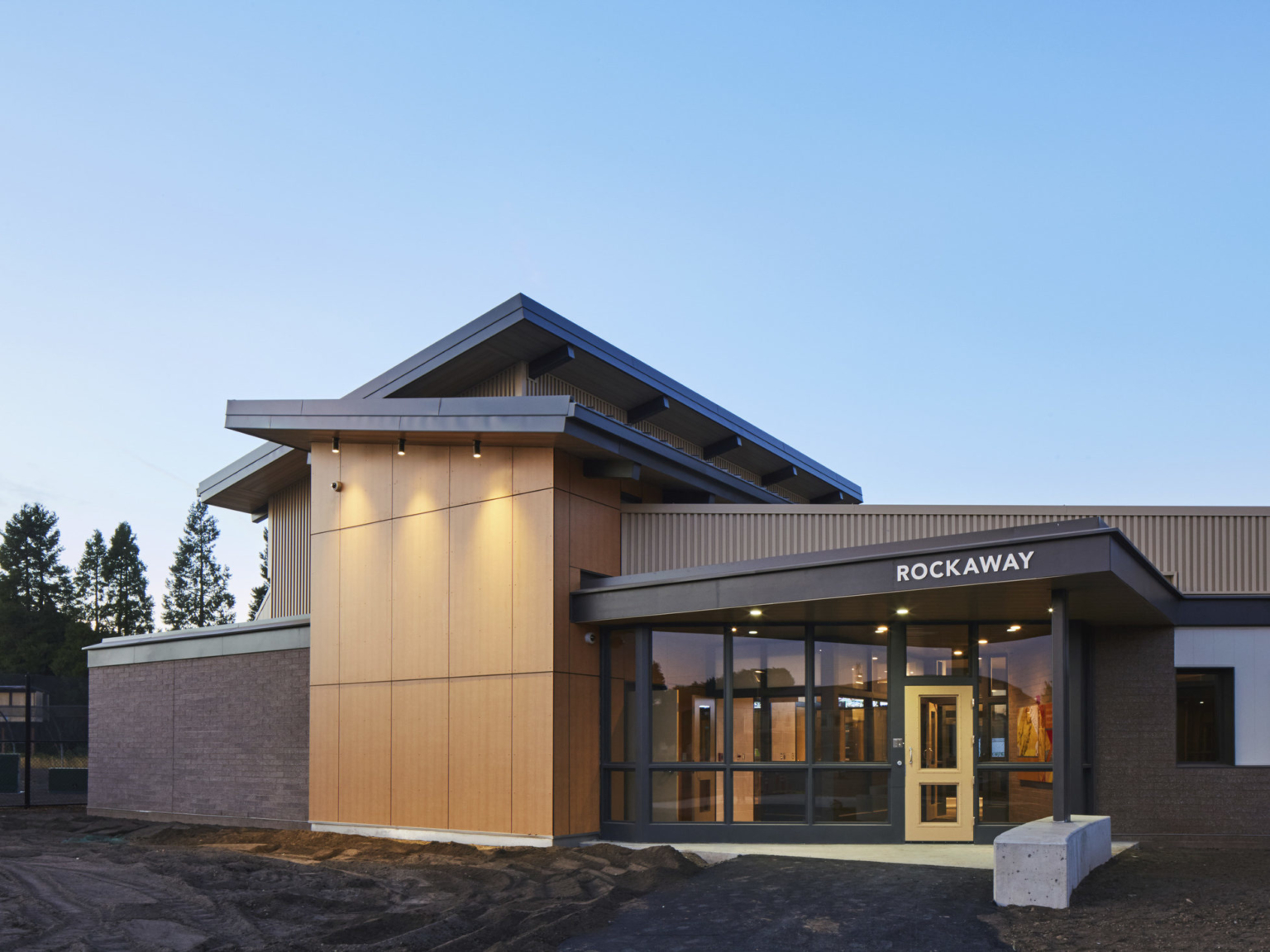eveing exterior view of rockwall entrance with a clear blue sky