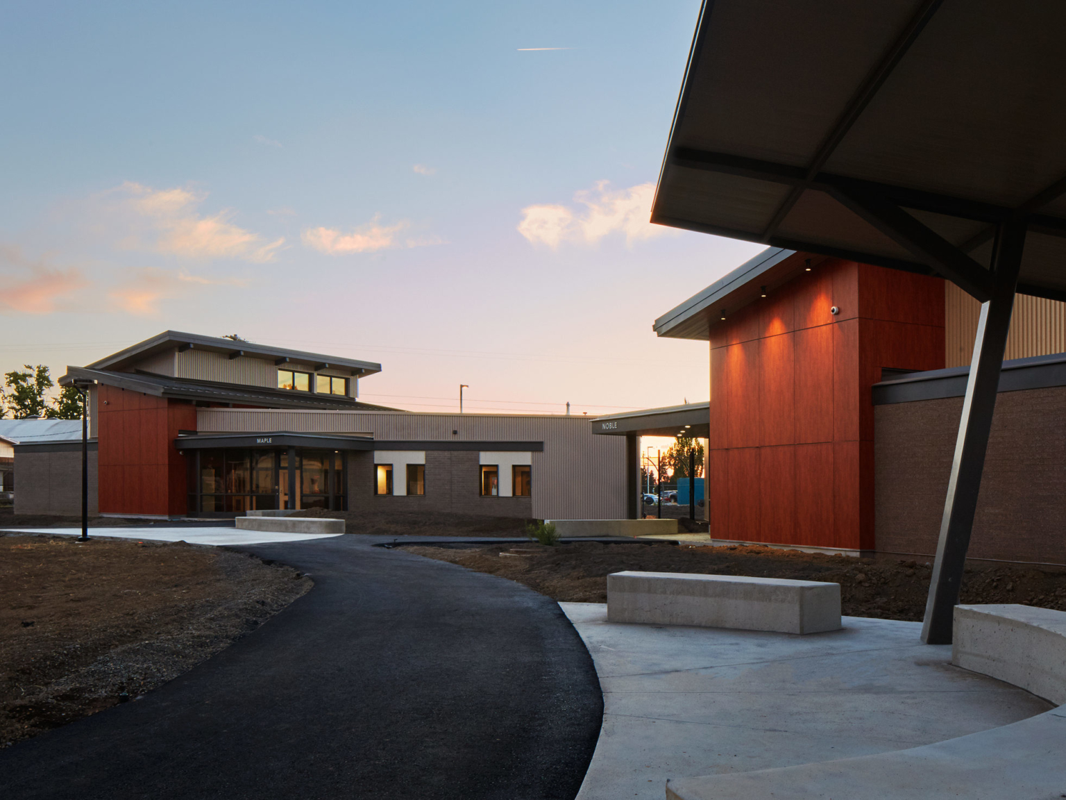 exterior view of a red and brown building at dusk