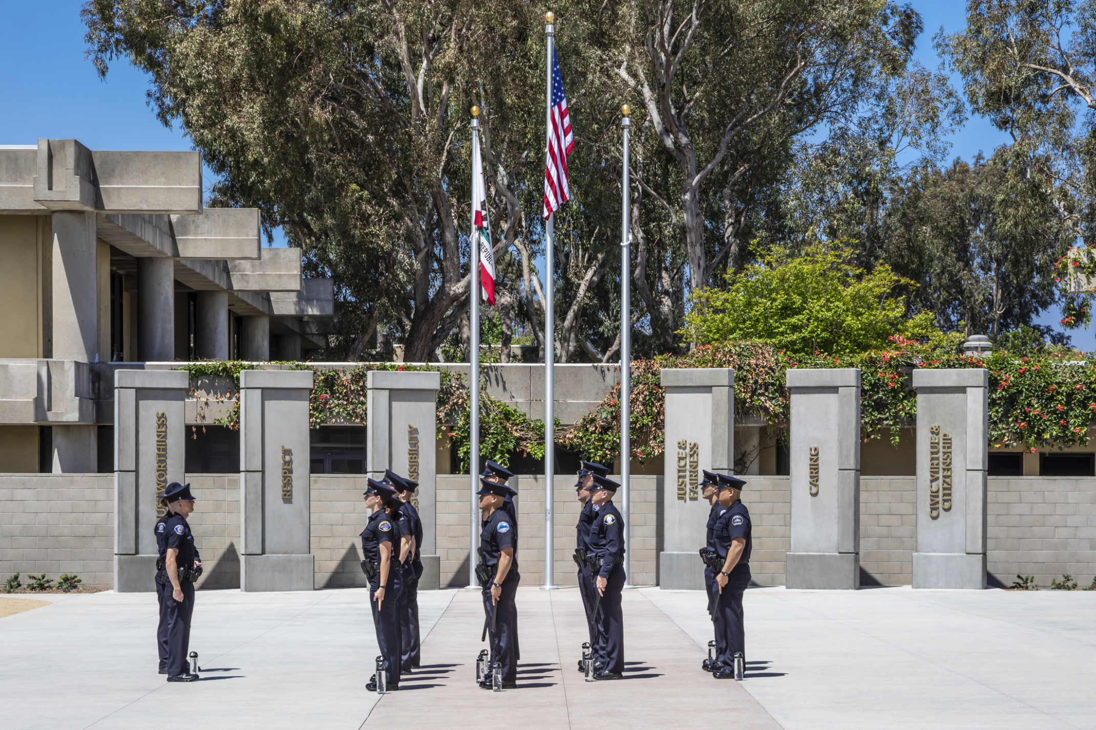 Officers lined up and standing in formation next to the US flags outside GWC Golden West College, Regional Public Safety Training Center. Officers lined up and standing in formation next to the US flags outside GWC Golden West College, Regional Public Safety Training Center.