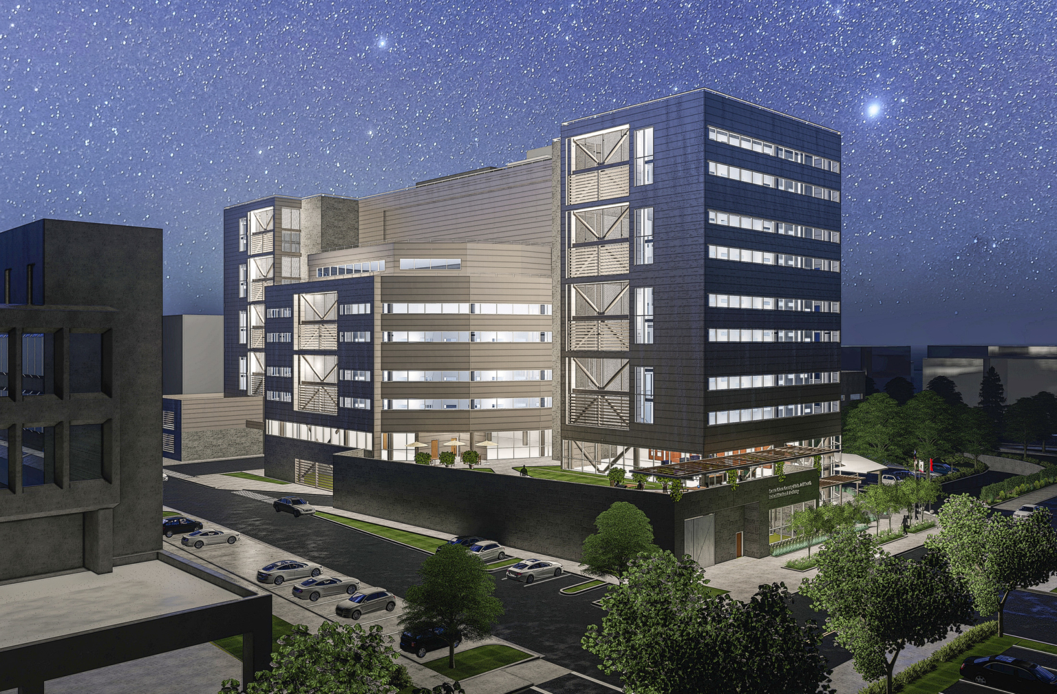 Night view with stars filling the sky overlooking the complex with large windows and a grey facade at Santa Clara County South Treatment and Re-Entry Facility.