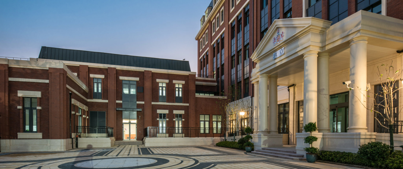 exterior view of Huili International School entrance with pillars at dusk
