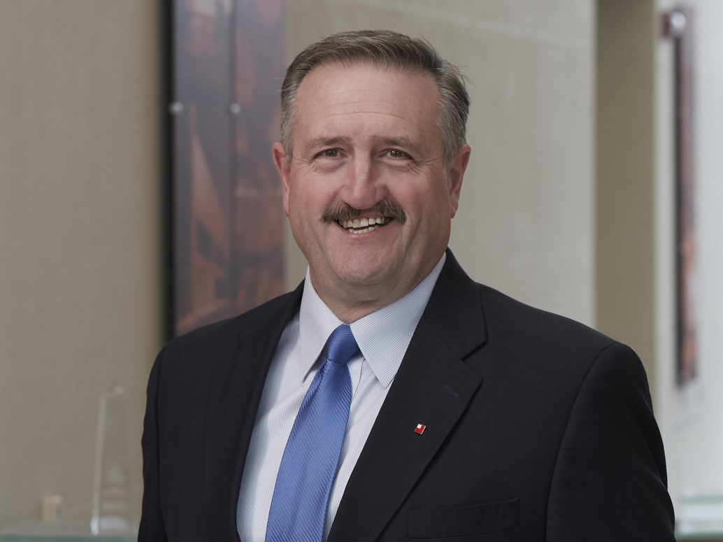 business man in a dark suit with a blue tie