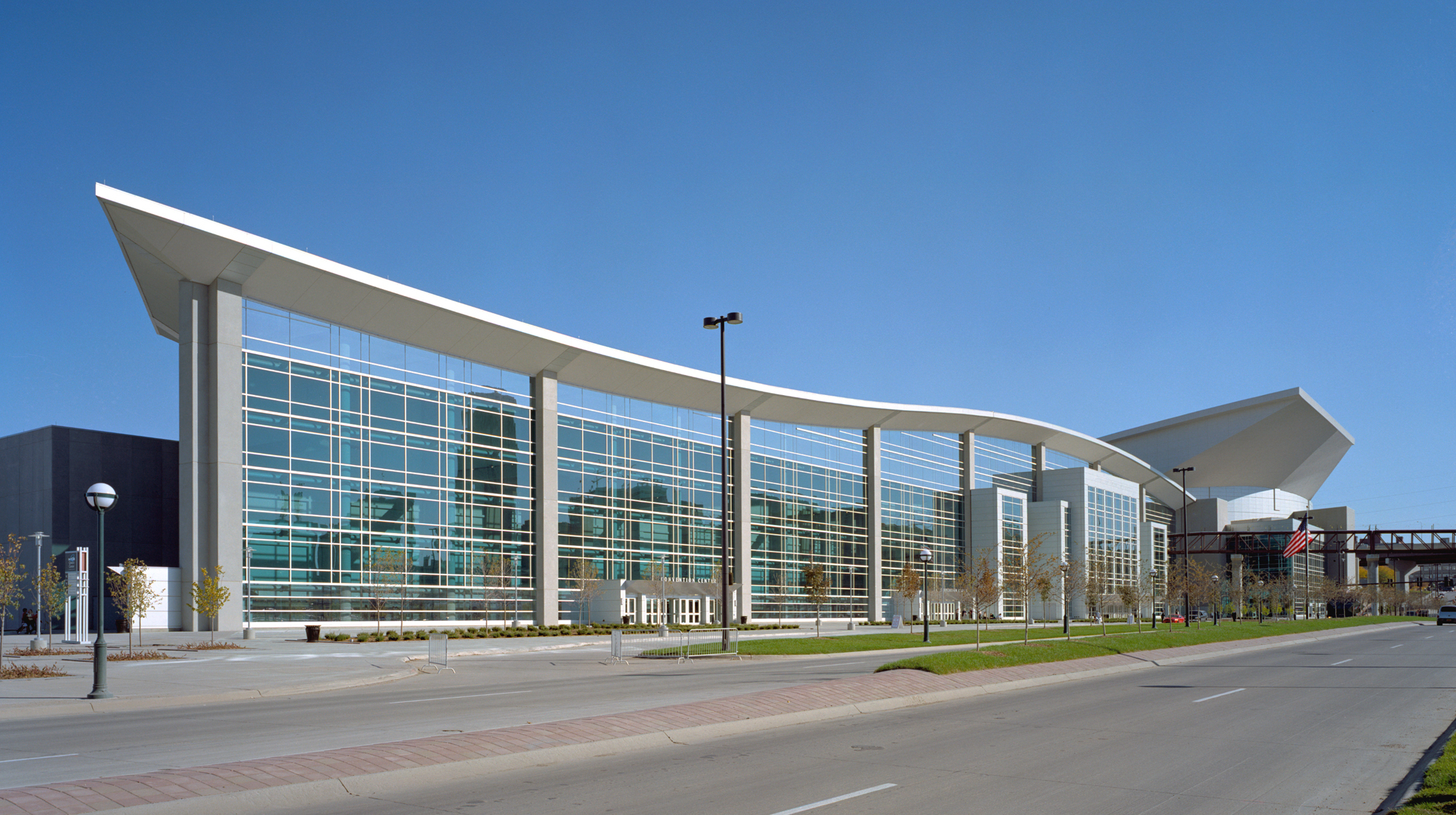 outdoor view of building with large windows and curved roof outdoor view of building with large windows and curved roof