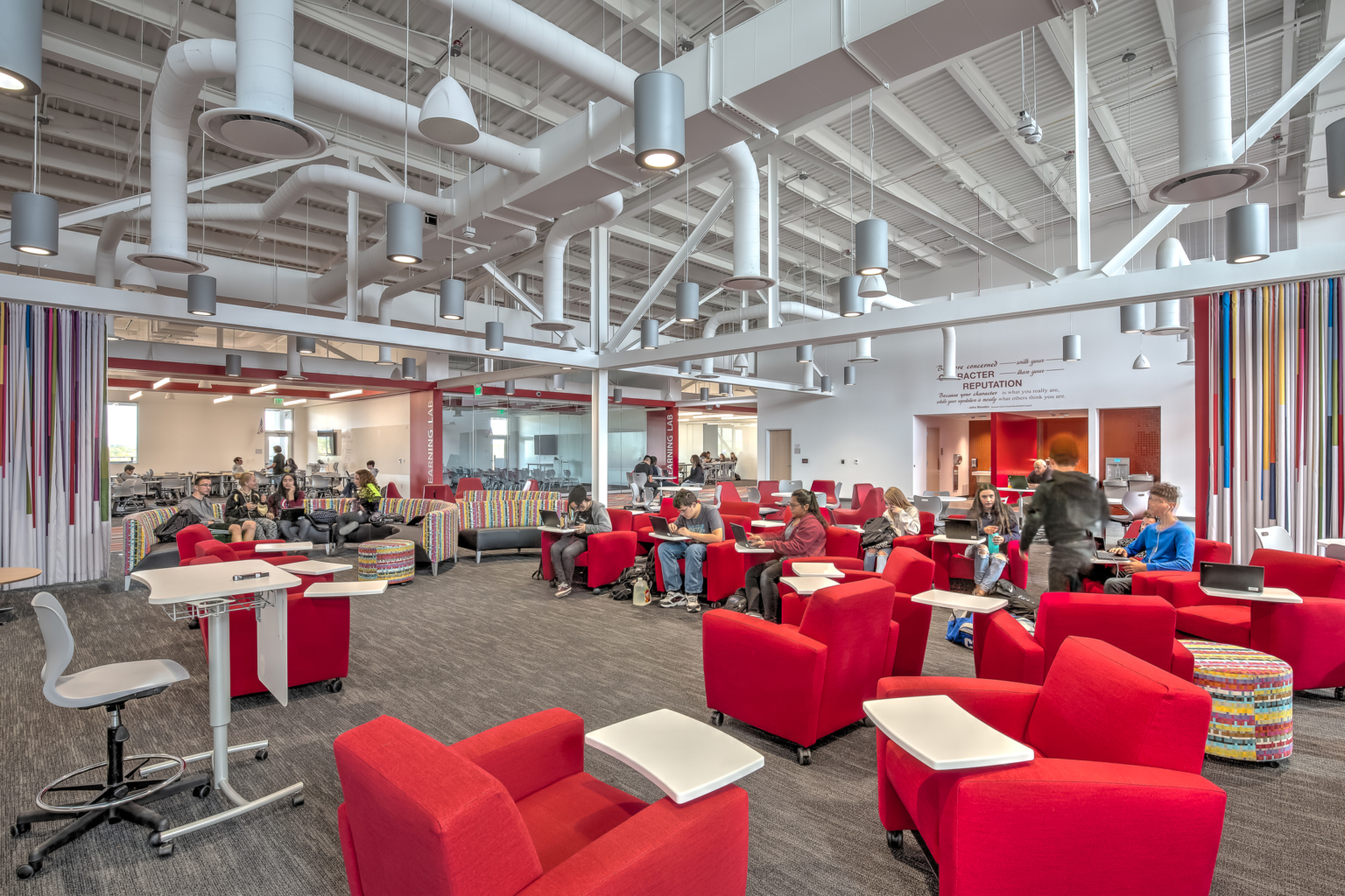 interior flexible classroom with movable walls and red upholstered seating