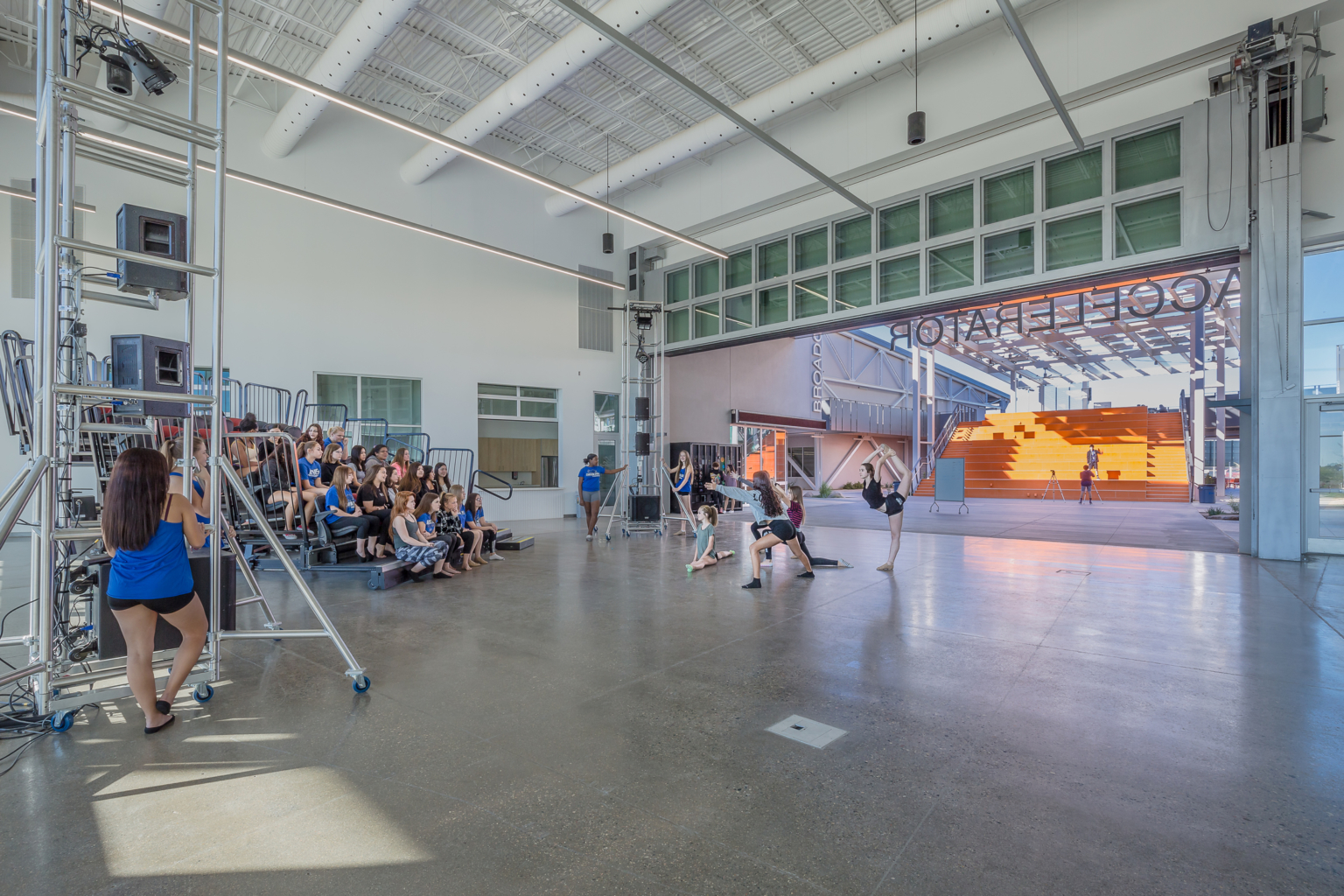 an open space with a glass garage door and polished concrete floor