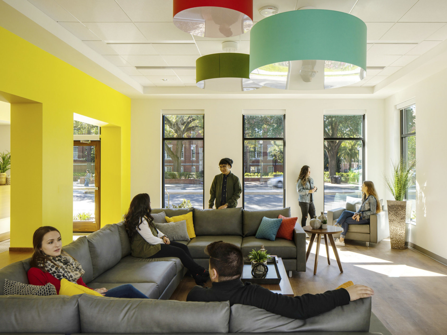 gray leather sofas facing a wall of windows