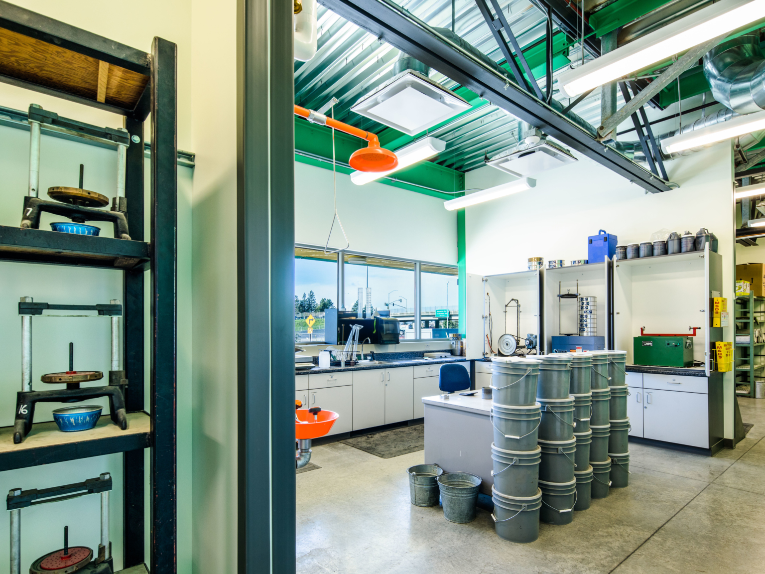 inside lab with countertops sinks shelves and stacked buckets