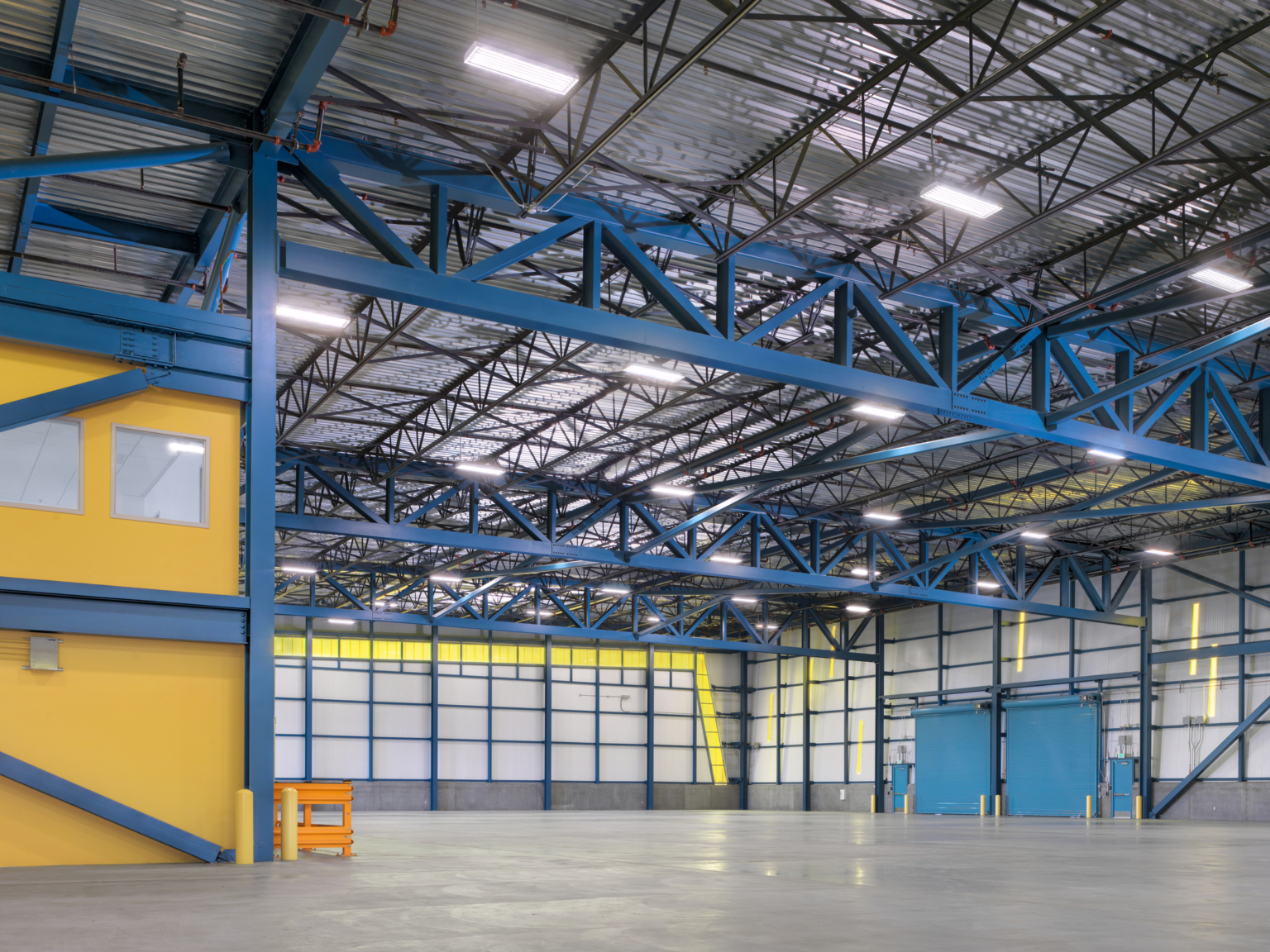 inside cargo building with blue and yellow structures