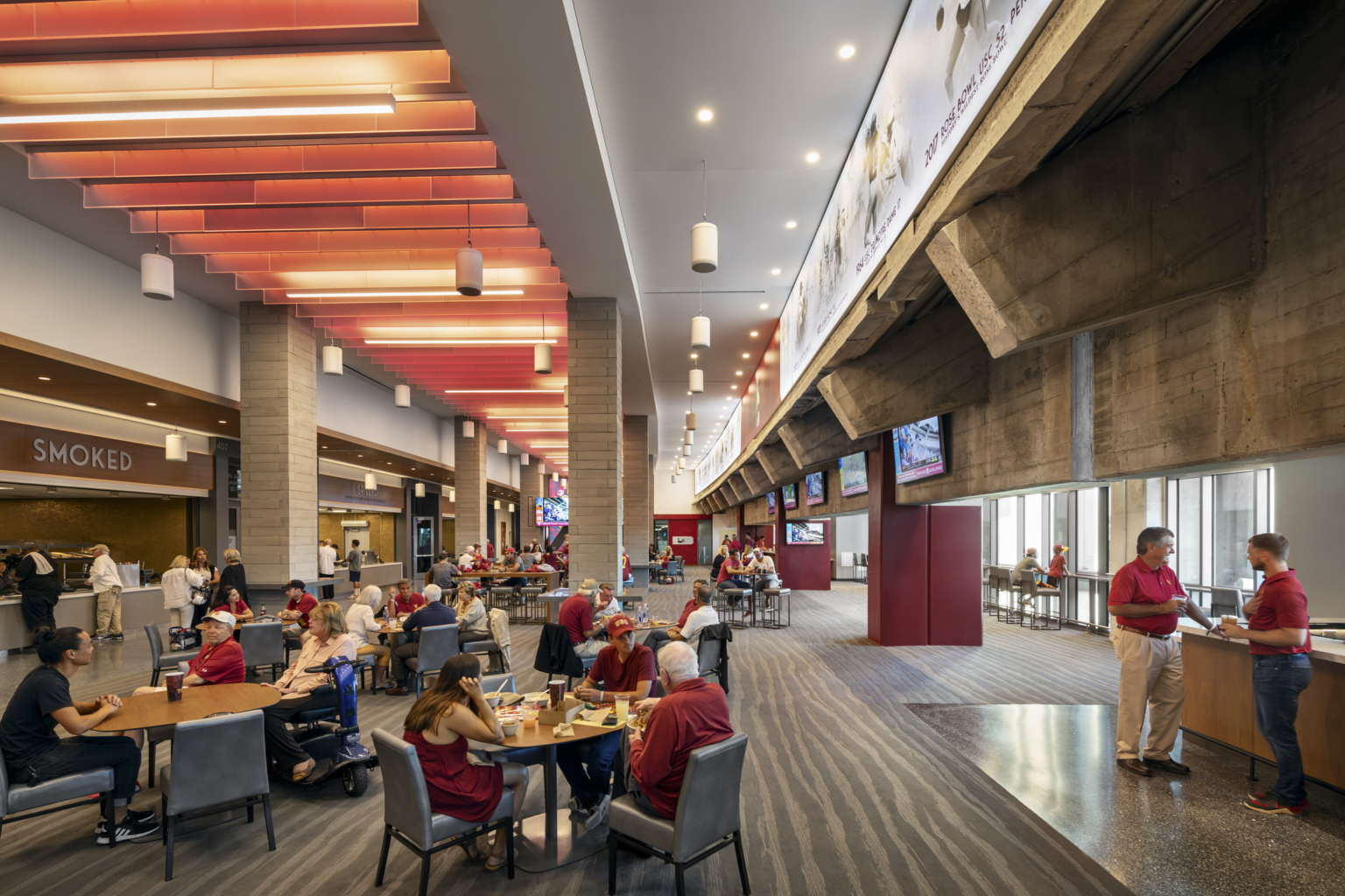 the lou galen club features the USC brand color palette and raw concrete from the stadium bowl