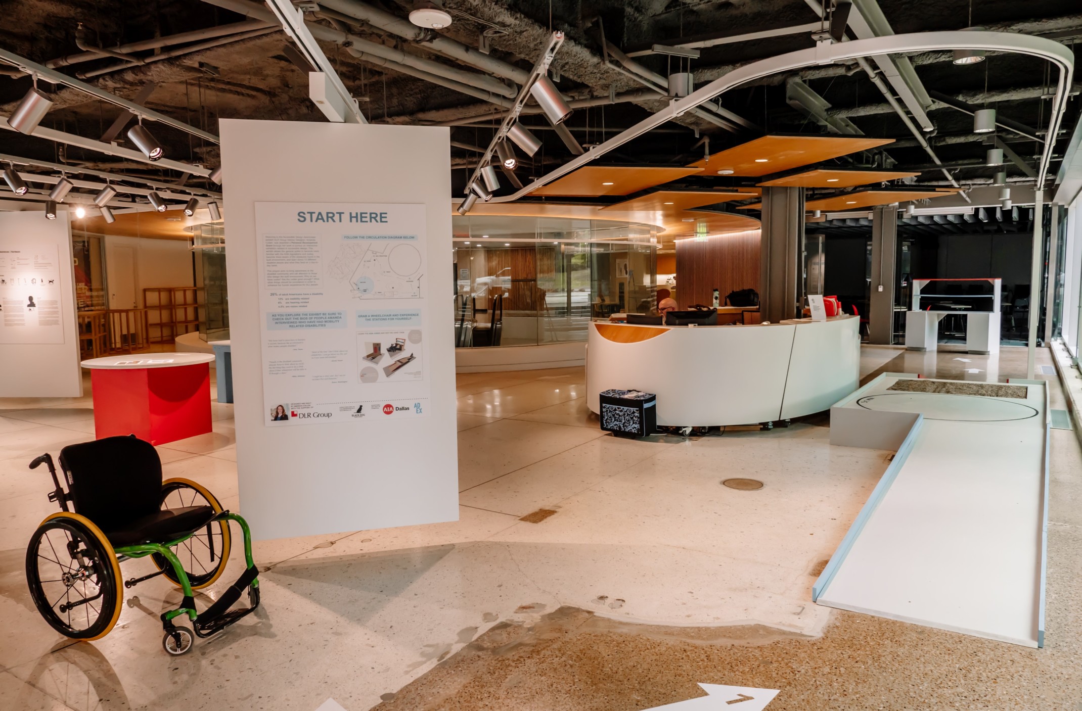 ADA accessibility design exhibit with a wheel chair ramp and plaques on display